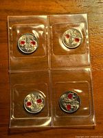 Front view of four colourized poppy quarters in individual flips
