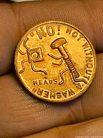 Obverse showing screw and washer design with inscription