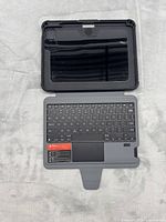 Keyboard folio case opened showing keyboard, trackpad, shell interior