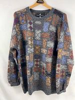 Front view of entire sweater displaying pattern and style