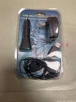Front view of sealed package showing wall and car adapters and cable