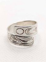 Front three-quarter view of engraved sterling silver open band ring