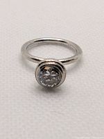 Top view showing bezel-set round clear cubic zirconia and silver band