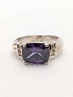 Front view of ring showing cushion amethyst and accent stones