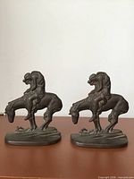 Front view of both bookends showing horse and rider figures