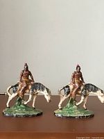Both bookends front view showing figures and paint condition