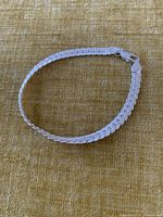Bracelet closed in oval showing flat links and clasp