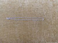 Entire necklace laid flat on fabric, showing full length
