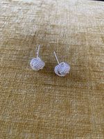 Front view showing both silver mesh knot stud earrings