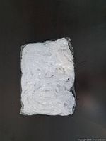 Sealed plastic bag with numerous white bouffant caps