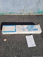 Closed rectangular box labeled Easy Built Models beside instruction sheet