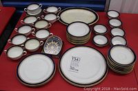 Royal Worcester fine bone china set arranged on table showing plates, cups, saucers, small platter and coasters.