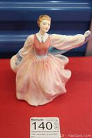 Front view of Royal Doulton 'Gay Morning' figurine showing face, bodice, and flowing sleeves.