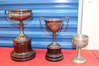 Three cups arranged side by side on red surface against blue background