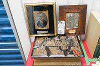 Two framed photographs atop the Bible showing overall lot