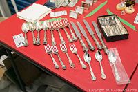Full view of the Birks Regency plate cutlery set including spoons, forks, knives, and Rogers silver plate teaspoons in black box.