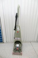 Full front view of the Bissell Quick Steamer floor cleaner, showing upright handle, power cord, and the brush housing.