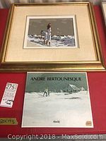 Painting and book displayed together on red surface