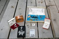Photo showing entire lot including wood jewellery box, jade necklace box, blue felt-lined box of charms, butterfly keychain box, Christmas pin box, gold stud earrings, and other costume jewelry.