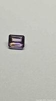 Front view of emerald-cut ametrine showing bicolour zoning