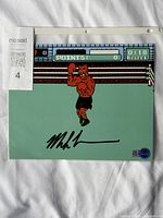 Full view of autographed photo in sleeve with WWOC hologram and MaxSold tag