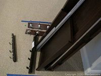 Full view of wall hooks and wall shelves laid on carpet, showing size and materials.