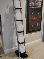 Full view of the floor lamp showing the angled metal frame and five frosted square glass shades on black shelves.