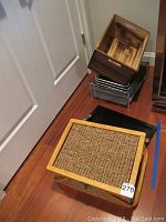 Overall view of all items stacked including picnic basket at the bottom, wooden box on top, and wire baskets