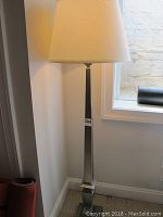 Full view of floor lamp with shade and base visible
