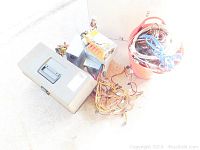 View of grey plastic toolbox, power supplies units, and bucket with cables