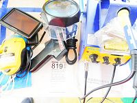 Photo showing BAKU601D soldering station, Weller soldering iron, laser level, TomTom GPS, and cords.