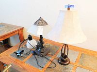 Photo showing the 2 table lamps and 1 clip lamp on a table with a tile inlay.