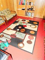 Full view of the carpet in a room showing the overall design and colors.