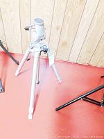 Full view of Silk Master tripod in collapsed position showing three legs with rubber feet and adjustable mounting head.