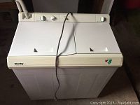 Front view of compact Danby washer and rinsing machine with top lids and control dials.
