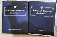 Two black binders with gold lettering labeled 'Statehood Quarters Collection' by Postal Commemorative Society, closed view
