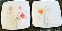 Four Geranium and two Sunflower floral design square salad plates arranged flat to show front designs.