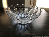 Side view of clear crystal punch bowl showing leaf pattern and scalloped rim.