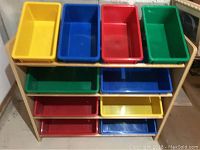Wooden rack containing 10 multi-colored plastic storage bins; colors include yellow, blue, red, and green. Bins arranged in three rows and holdable within individual slots of rack.