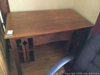 Front and top view of the quarter cut oak wooden desk showing grain pattern and bookshelf sides