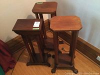 All three wooden plant stands grouped together