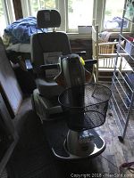 Front-left view of scooter showing three wheels, black wire basket, seat and tiller