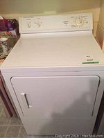 Front view of white Hotpoint dryer showing door and control panel above it.