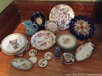 Group photo of all plates and items including the Wade jug and salt and pepper set