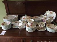 Overall set of Shelley Begonia china including plates, cups, saucers, teapot, and serving pieces arranged on wood surface