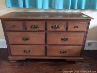 Front view of the Vilas colonial style maple double dresser showing six drawers with metal and knob handles.