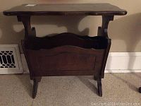 Front view of the wooden magazine table showing the flat top, magazine compartment, and legs.