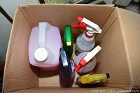 Box of assorted automotive cleaning products and spray bottles with the Black and Decker polisher box on side.
