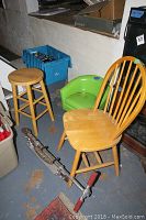 Four items in the lot shown together: a wooden stool, a green vinyl child chair, a wooden spindle back chair, and a Razor scooter on the floor.