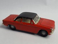 Side angle showing the black roof, red body, and details of the Corvair Monza toy car.